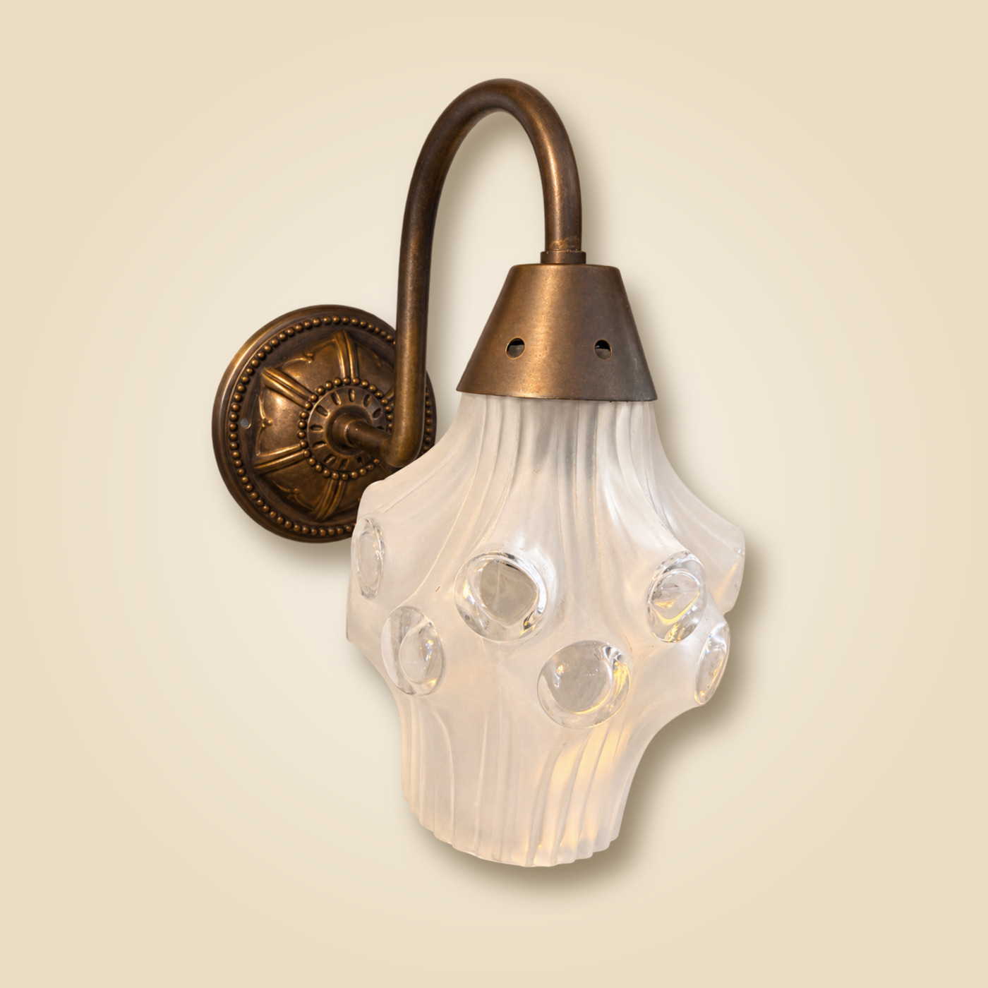 Bronze Gooseneck Wall Sconce with Embossed Round Wall Plate and Frosted Ribbed Glass Shade Set with Clear Glass Cabochons — K76 — Angle 1