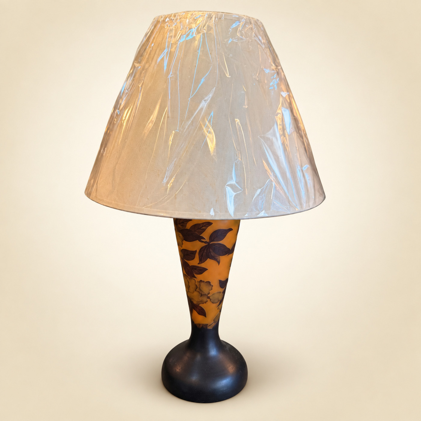 Table Lamp with Cameo-Style Amber-Orange Glass Body with Dark Leaf and Flower Motif, Dark Metal Base and Cream Cone Shade — S104 — Angle 1