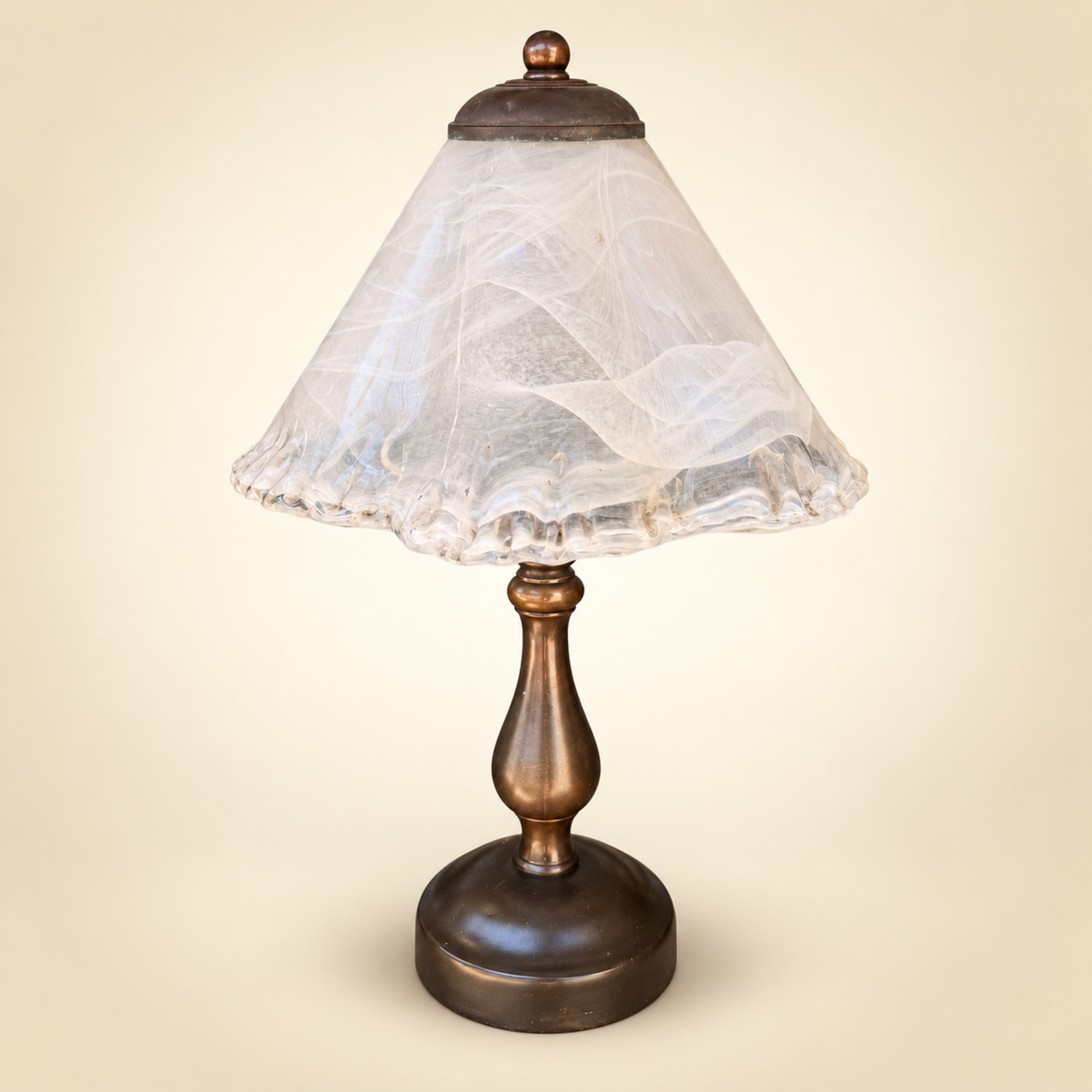Table Lamp with White Swirled Glass Cone Shade with Ruffled Rim and Bronze Cap with Finial, on a Bronze Baluster Stem and Dark Round Base — S154 — Angle 1
