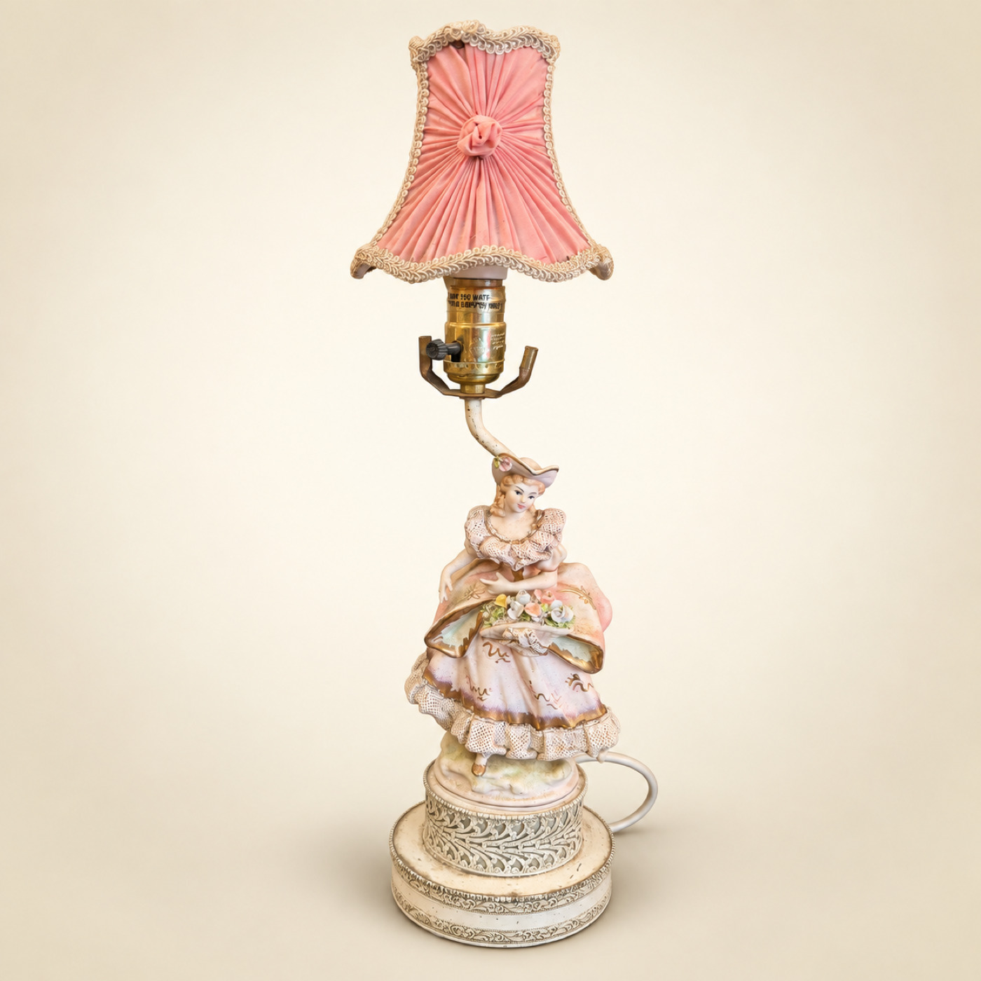 Table Lamp with Porcelain Lady Figurine in a Lace Dress, Pink Pleated Fabric Shade with Trimmed Edge and Ornate Round Base — S89 — Angle 1