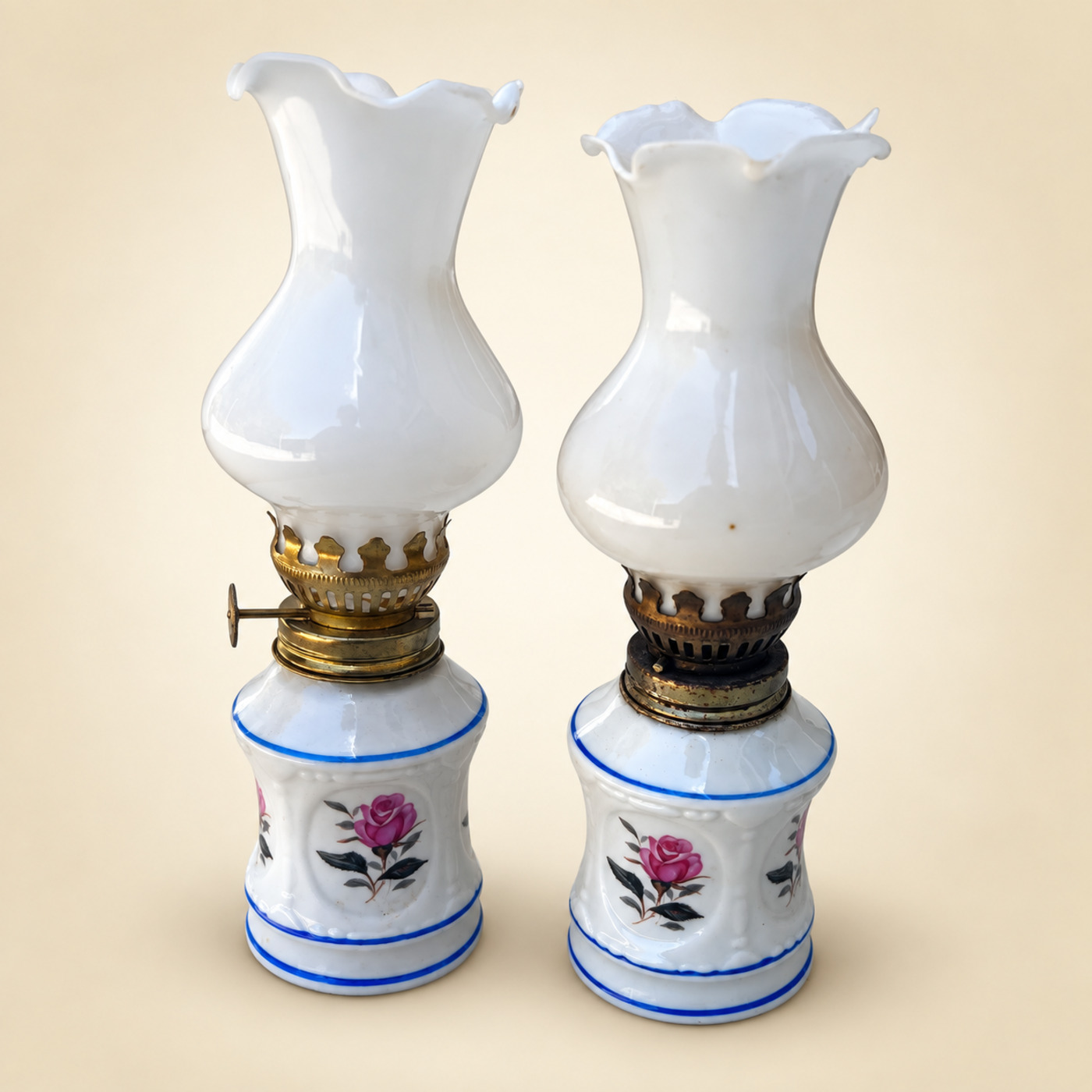 Pair of Miniature Porcelain Oil Lamps with Pink Rose Medallions and Blue Bands, Brass Burners and White Opaline Glass Chimneys with Ruffled Rims — P26 — Angle 1